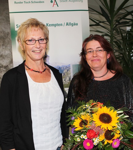 Marlene Preißinger, Stellvertreterin des Landrats, überreichte bei der Eröffnung der Ausstellung „Wege aus der Sucht“ Blumen an Initiatorin Cornelia Beyrer. Foto: Eva Büchele / Landratsamt Unterallgäu